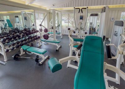 Gym Features Mirrors Along The Walls & Dedicated Area For Floor Exercises