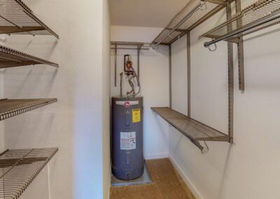 Utility Closet Containing Water Heater & Wire Shelving For Storage